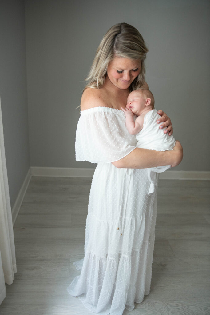 beautiful mother holding baby in studio by valerie maria photography