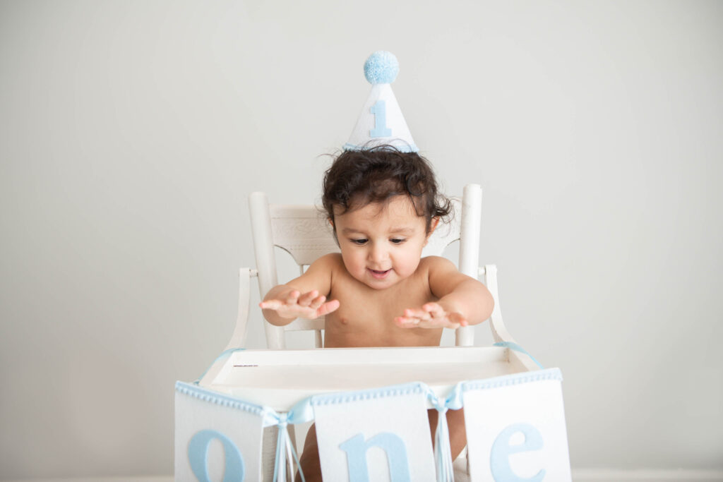 white and blue birthday celebration for baby's first birthday in Valerie Maria Photography studio 
