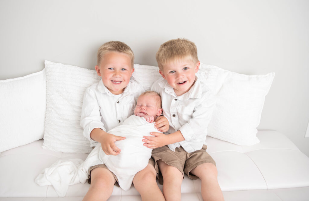 boy sibling photo with newborn by Valerie Maria Photography