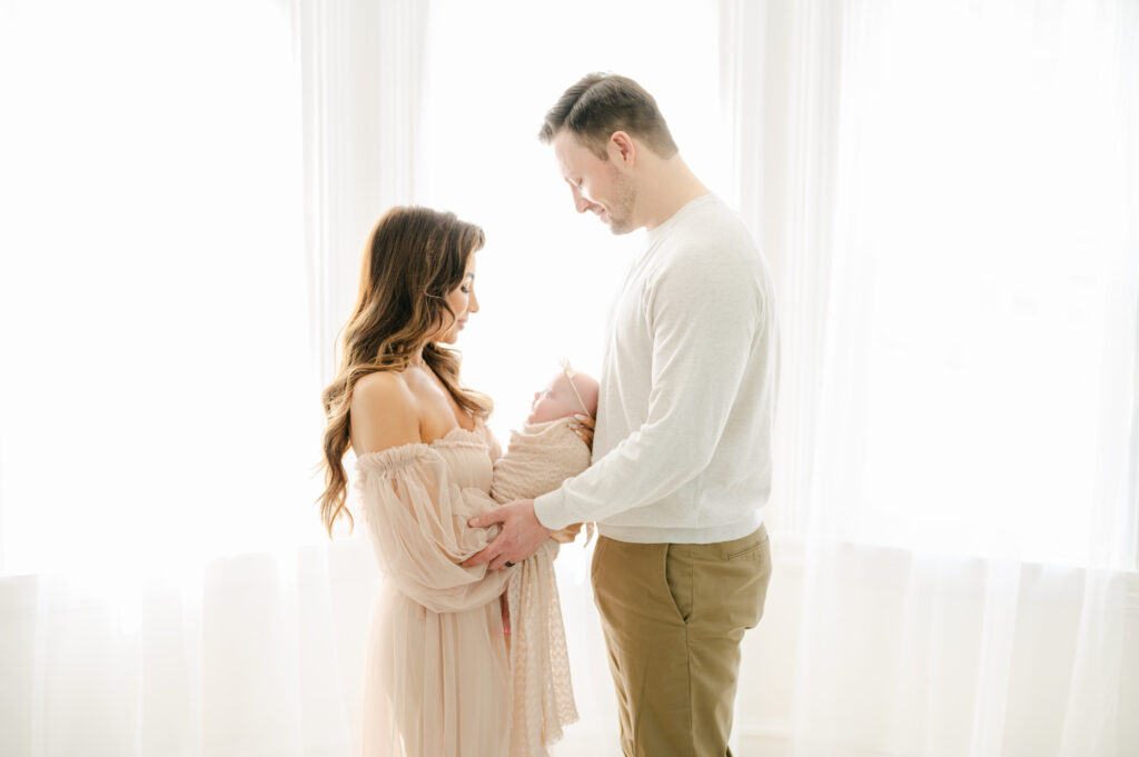 couple with baby, neutral colors